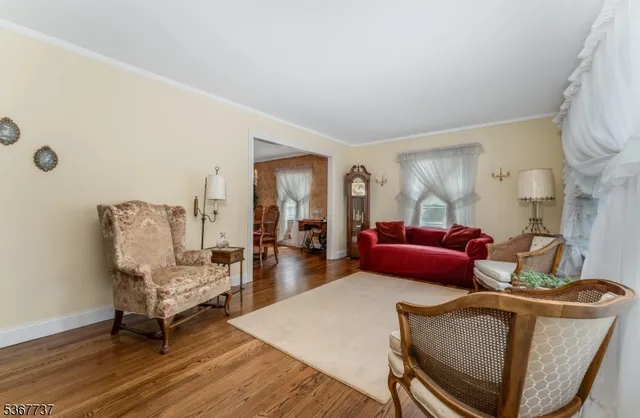 a bedroom with a bed and large windows