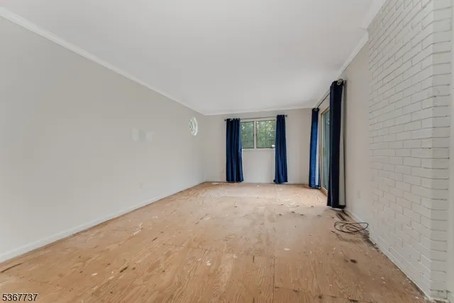 a view of balcony with wooden floor and fence