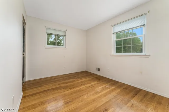 a view of balcony with wooden floor and fence