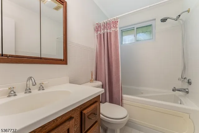 a front view of a house with a garden and plants