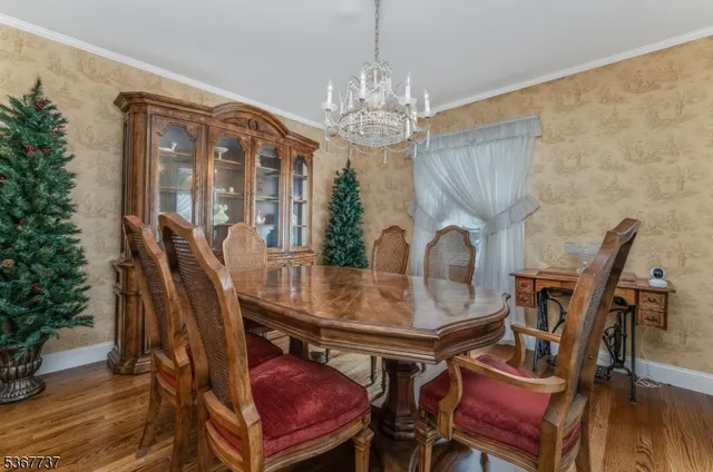 a dining room with furniture a chandelier and wooden floor