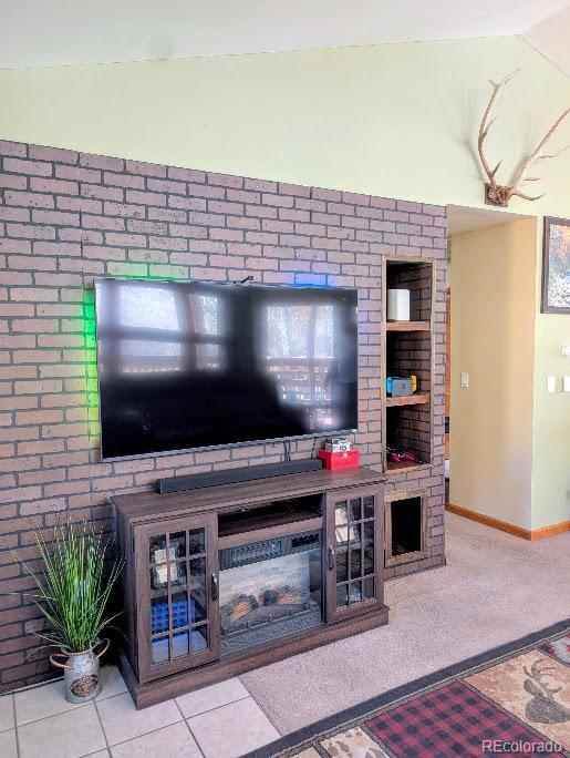 1418 Rose Street Georgetown, CO 80444 - Photo 28 of 33 a living room with fireplace furniture and a flat screen tv