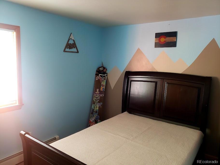 1418 Rose Street Georgetown, CO 80444 - Photo 30 of 33 a bedroom with a bed and a wall painting
