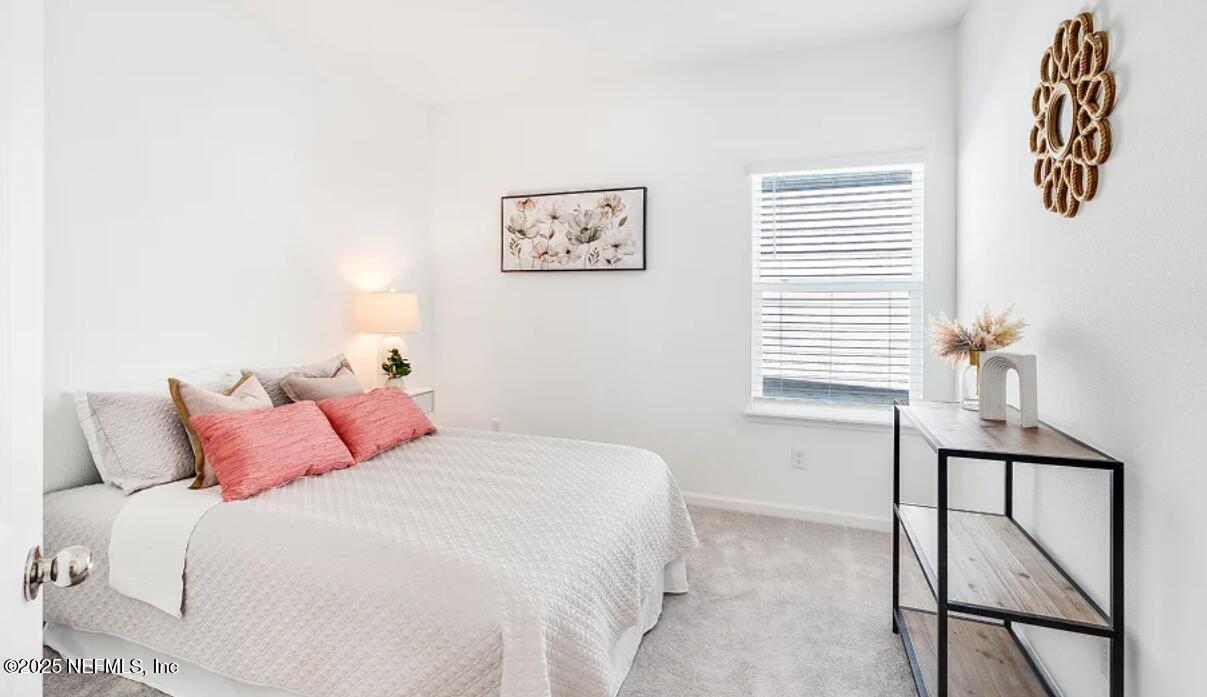 606 Kingbird Drive St. Augustine, FL 32092 - Photo 9 of 14 a bedroom with a bed and a window