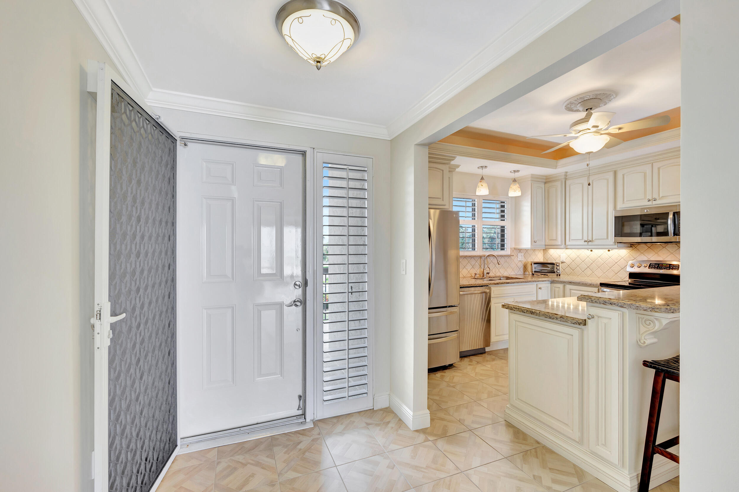 70 Celestial Way, Unit 203 Juno Beach, FL 33408 - Photo 20 of 75 Front Door & Kitchen