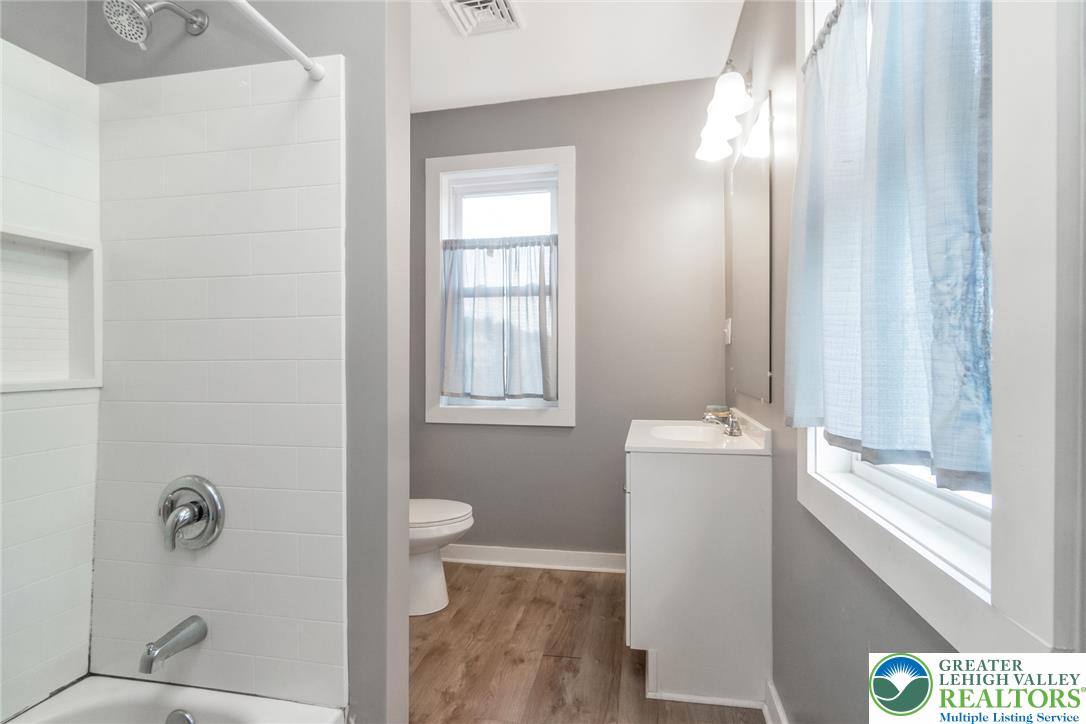 506 Richmond Road Bangor, PA 18013 - Photo 24 of 43 Natural light streams through multiple windows onto the LVP flooring of this updated bathroom with tub/shower.