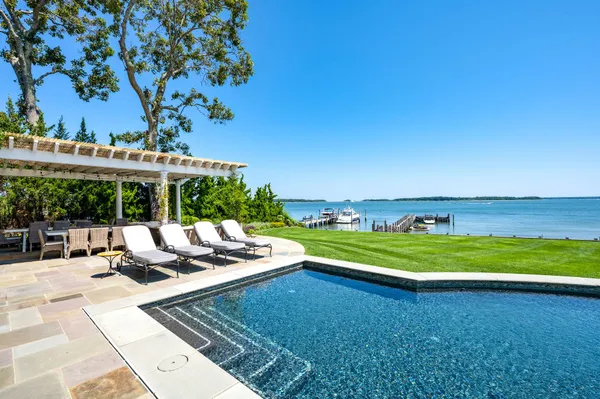 a view of a swimming pool and lounge chairs