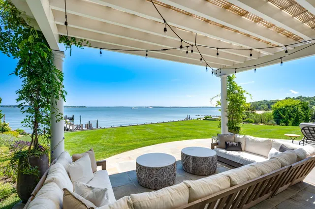 a view of yard from deck with patio