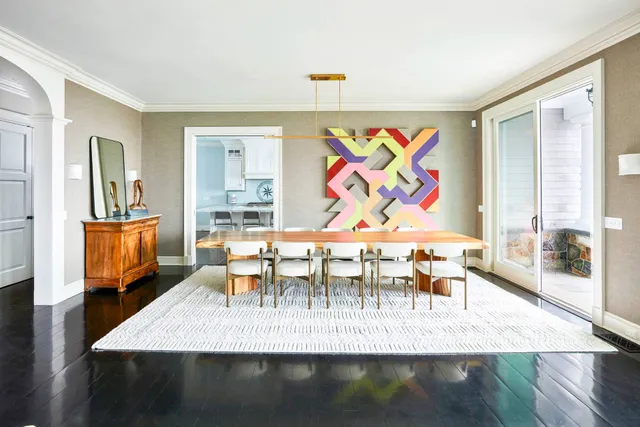 a view of a dining room with furniture a chandelier and wooden floor