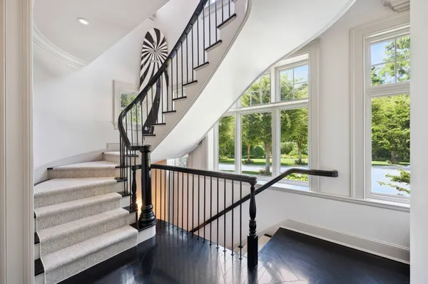 a view of entryway with wooden floor and front door