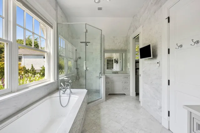a bathroom with a sink a mirror and a bathtub