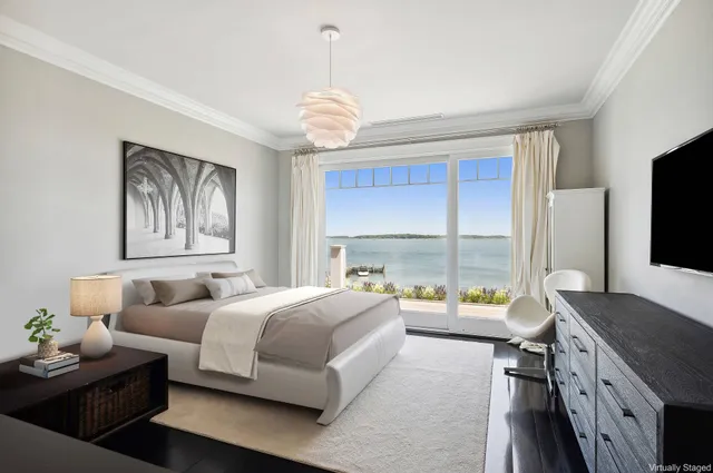 a bedroom with furniture and a large window