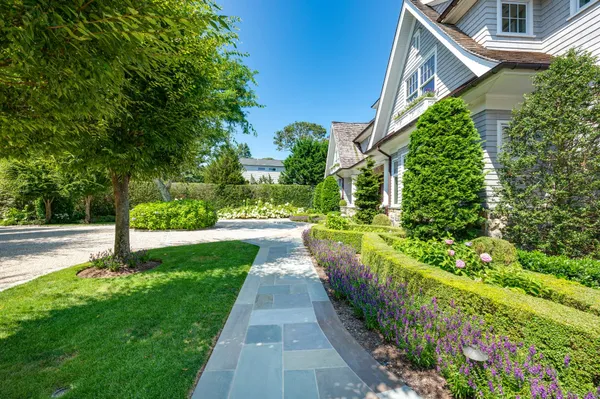 a view of a garden with a house