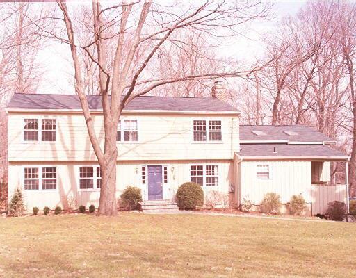 124 Catalpa Road Wilton, CT 06897 - Photo 1 of 1 front view of a house with a yard