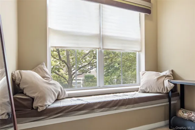 a living room with furniture and a baby crib