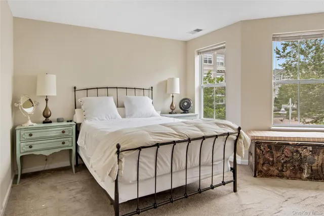 a bedroom with a bed and a painting on the wall