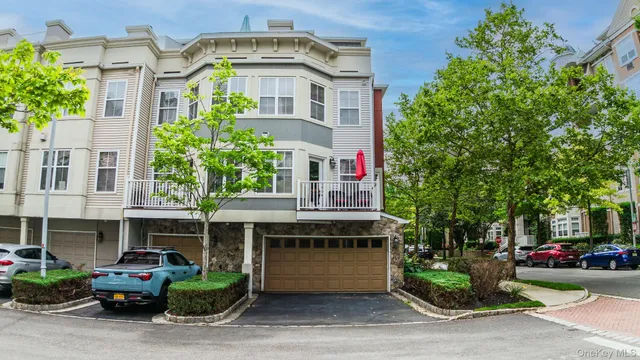a front view of a house with a yard and potted plants