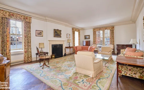 a living room with furniture fireplace and a window