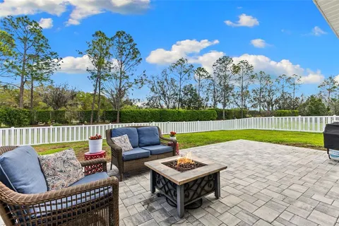 a view of swimming pool with garden and patio