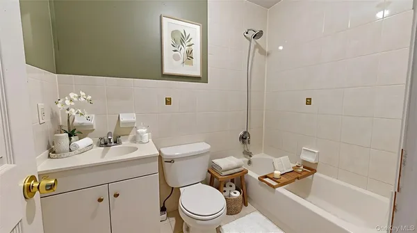 a bathroom with a sink mirror vanity and toilet