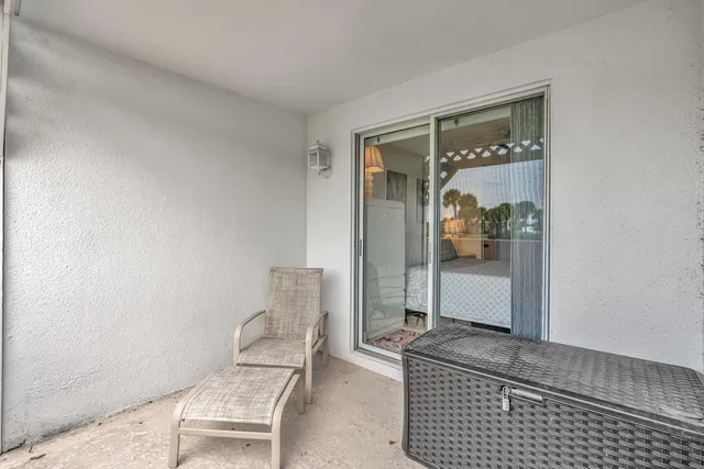 a room with a chair and potted plant