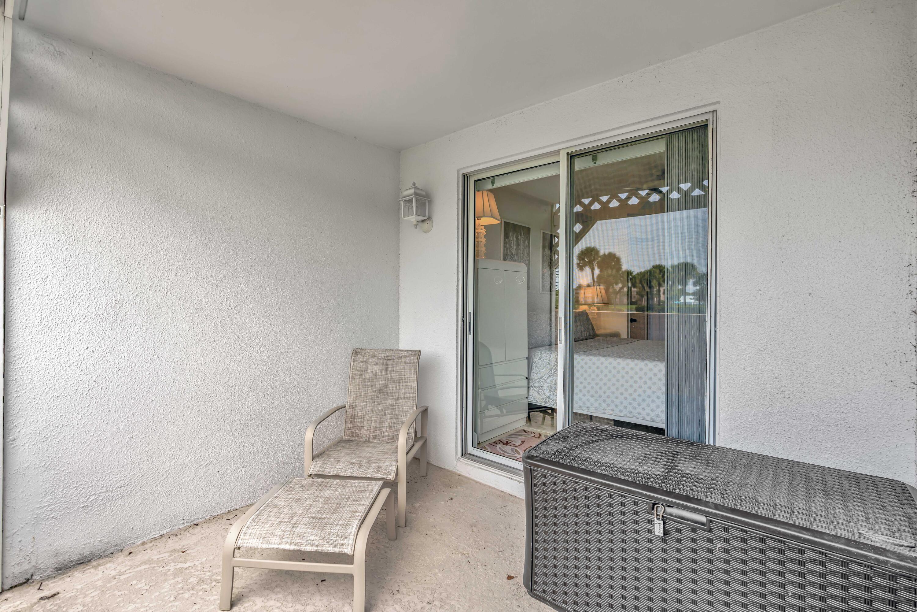 353 Highway 1, Unit A4 Jupiter, FL 33477 - Photo 18 of 51 a room with a chair and potted plant