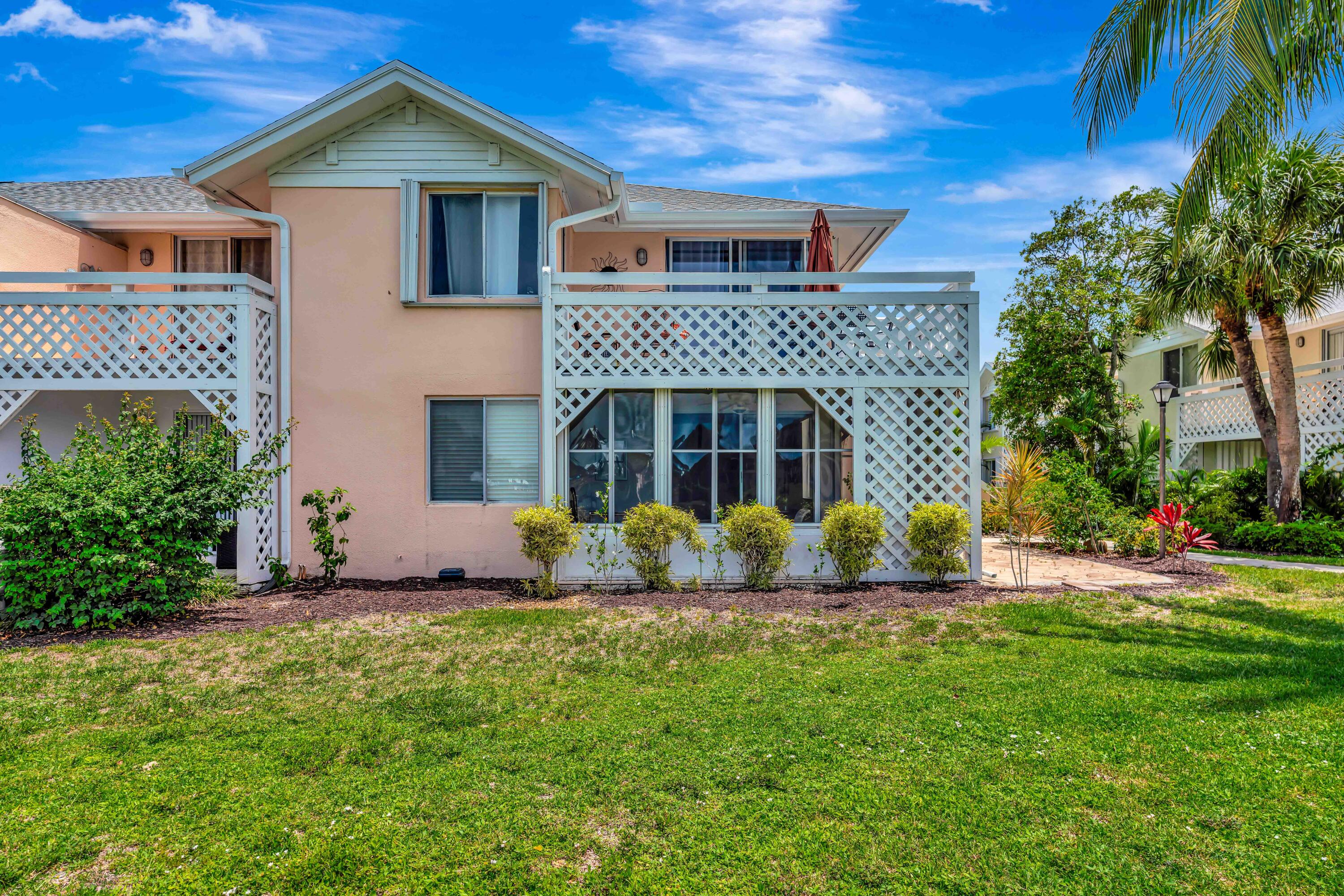 353 Highway 1, Unit A4 Jupiter, FL 33477 - Photo 19 of 51 a front view of a house with a yard and garage
