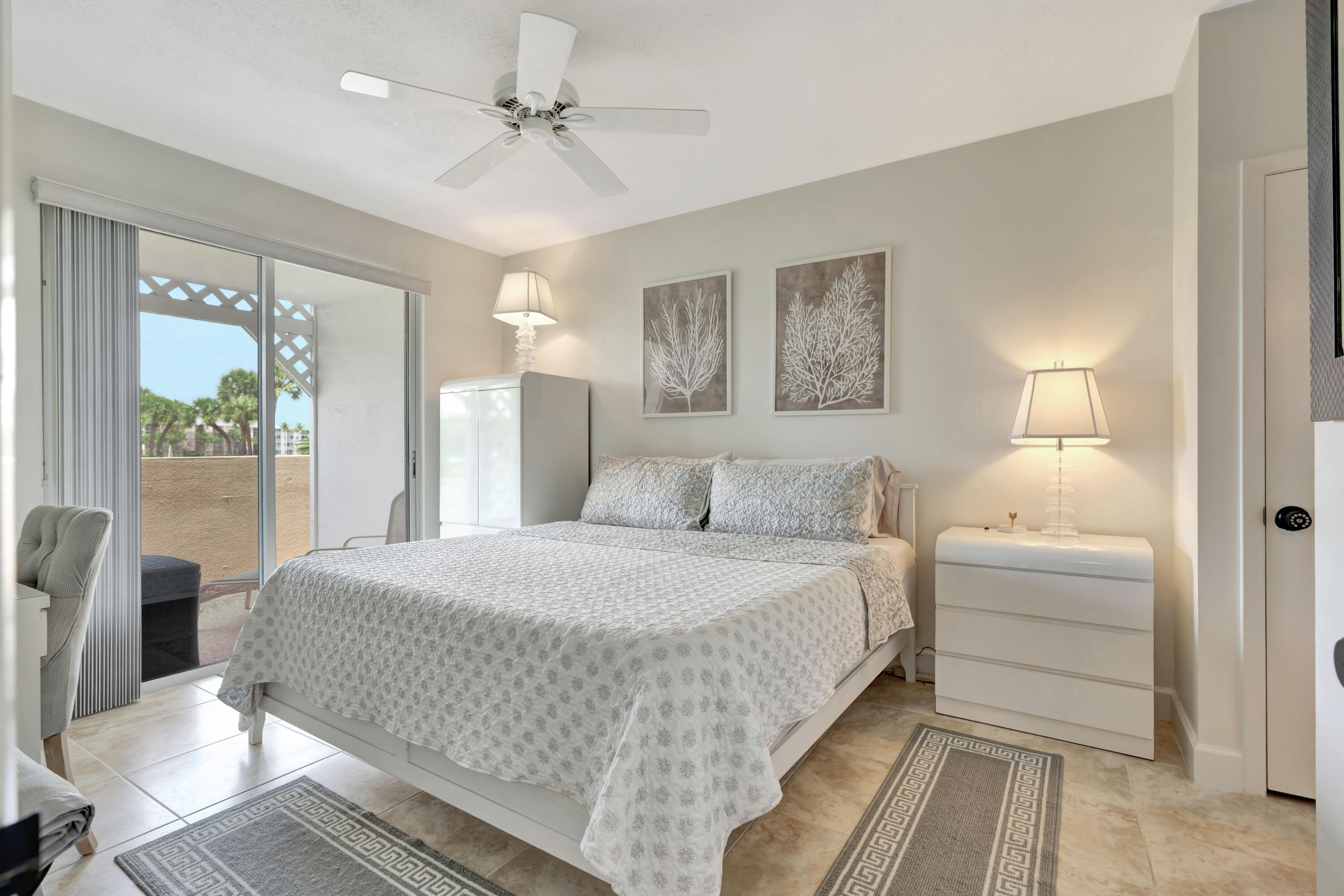 353 Highway 1, Unit A4 Jupiter, FL 33477 - Photo 22 of 51 a bedroom with a large bed and a chandelier