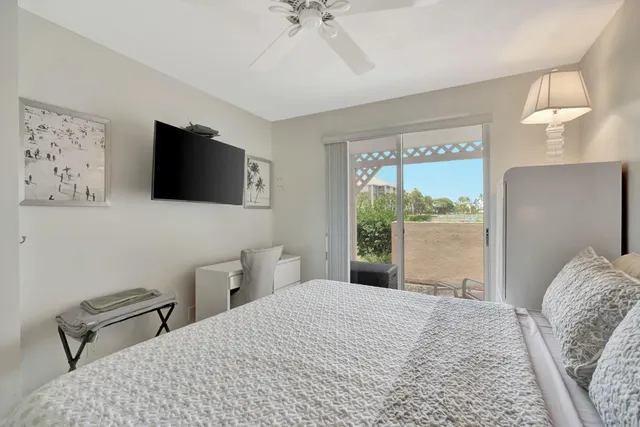 a bedroom with a bed window and a flat screen tv
