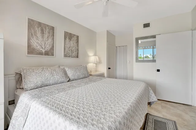 a bedroom with a bed and a painting on the wall