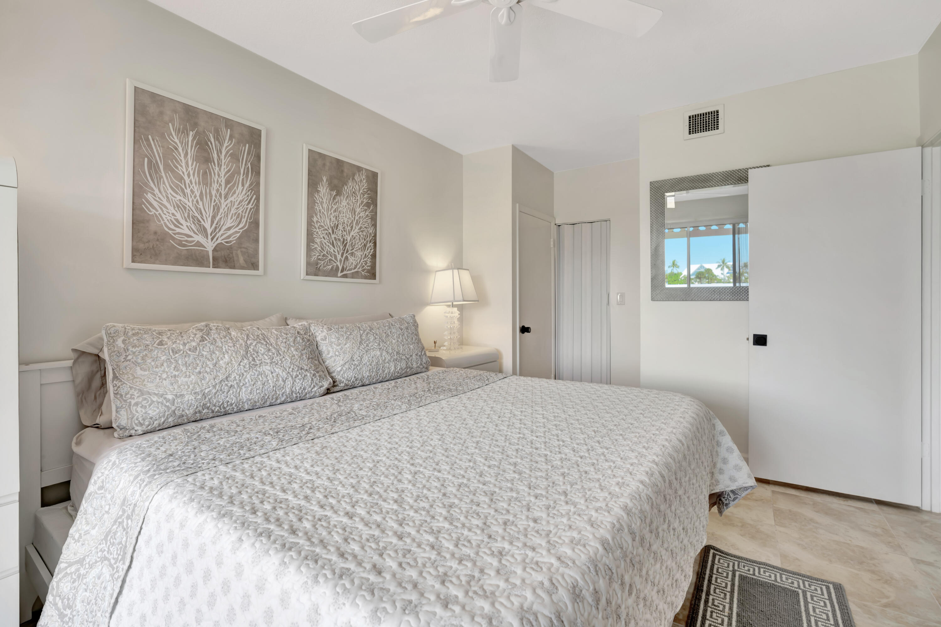 353 Highway 1, Unit A4 Jupiter, FL 33477 - Photo 24 of 51 a bedroom with a bed and a painting on the wall