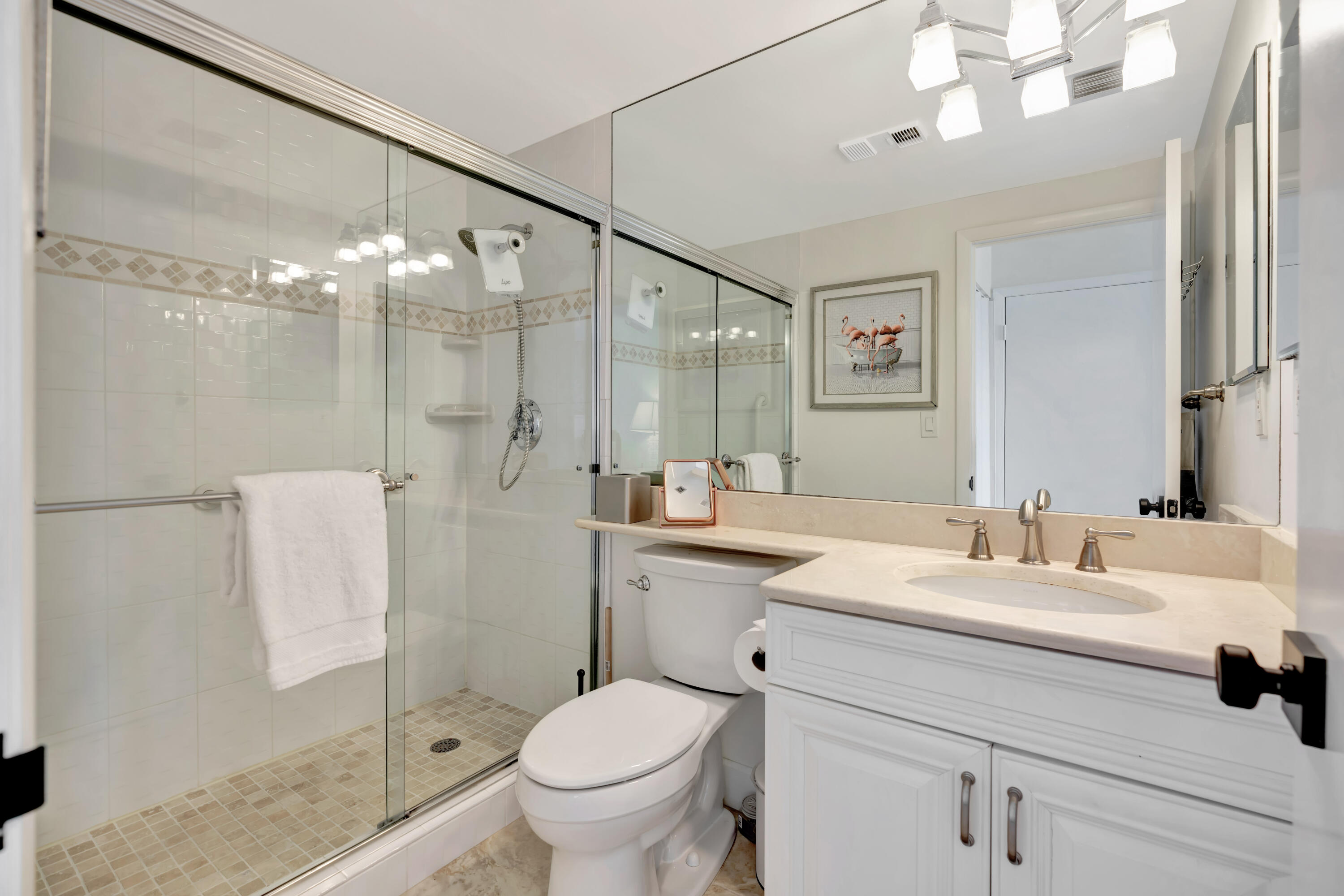 353 Highway 1, Unit A4 Jupiter, FL 33477 - Photo 25 of 51 a bathroom with a sink a toilet and shower