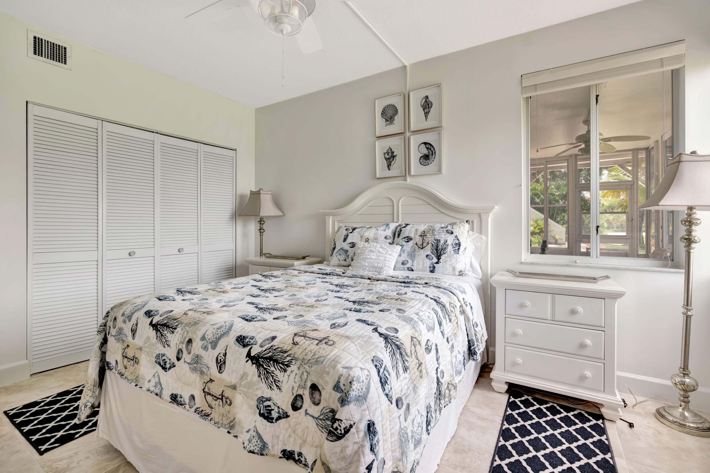 353 Highway 1, Unit A4 Jupiter, FL 33477 - Photo 26 of 51 a bedroom with a bed and wooden floor