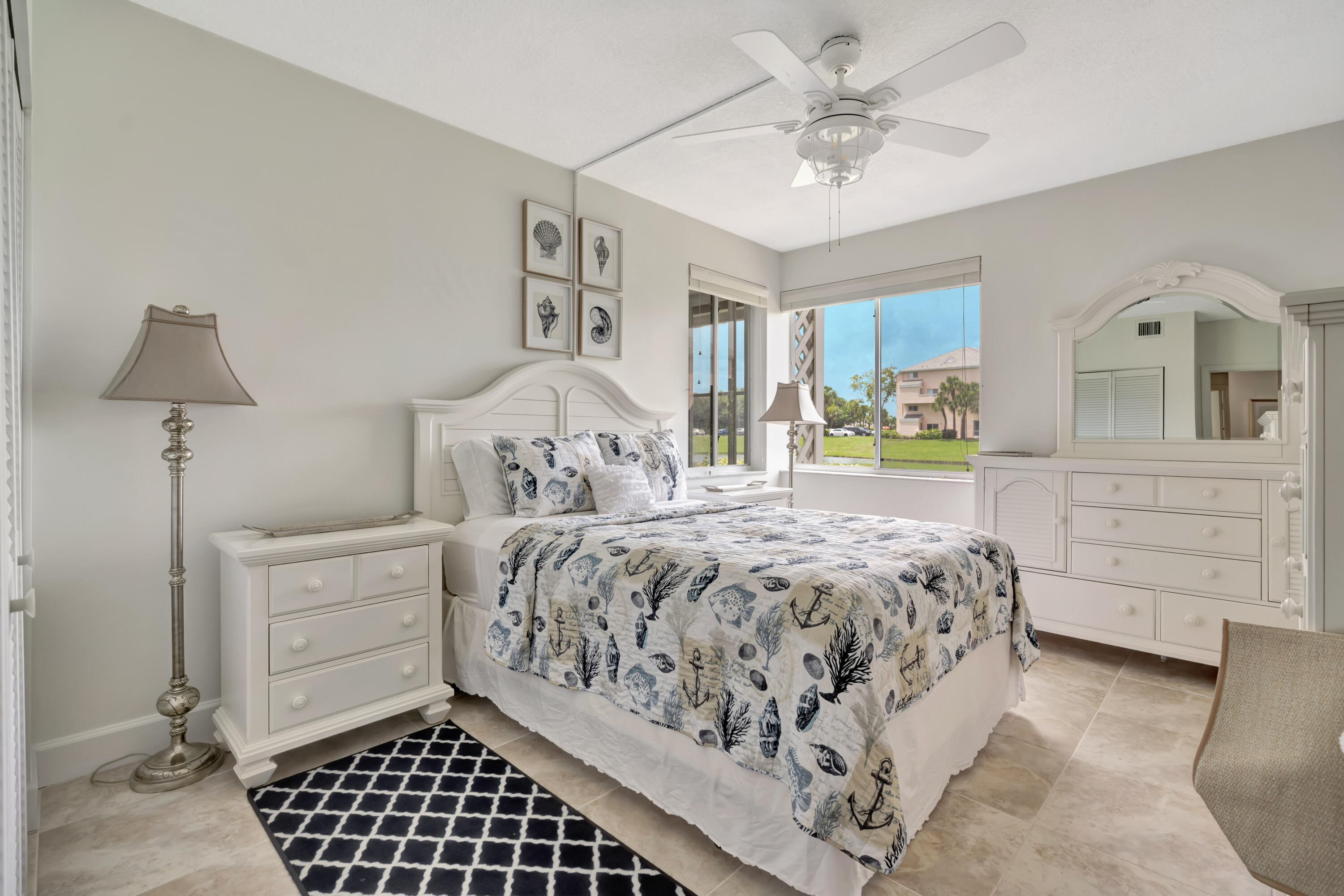 353 Highway 1, Unit A4 Jupiter, FL 33477 - Photo 27 of 51 a bedroom with a bed and a chandelier