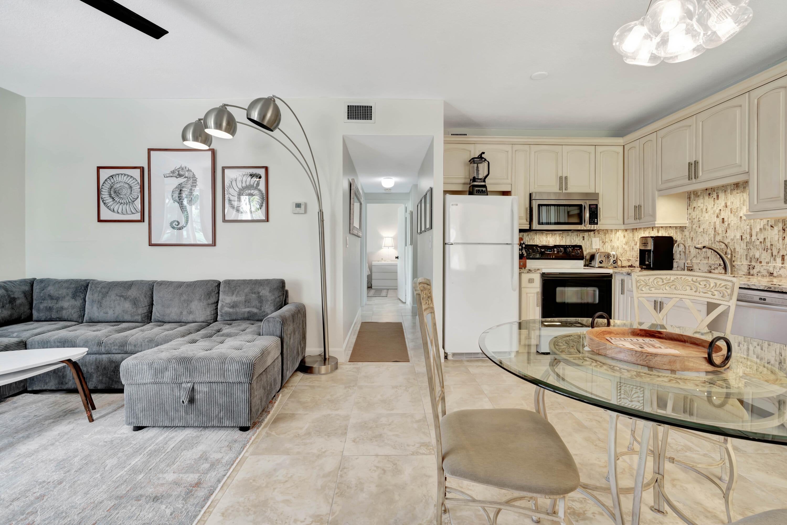 353 Highway 1, Unit A4 Jupiter, FL 33477 - Photo 7 of 51 a living room with furniture and a kitchen view