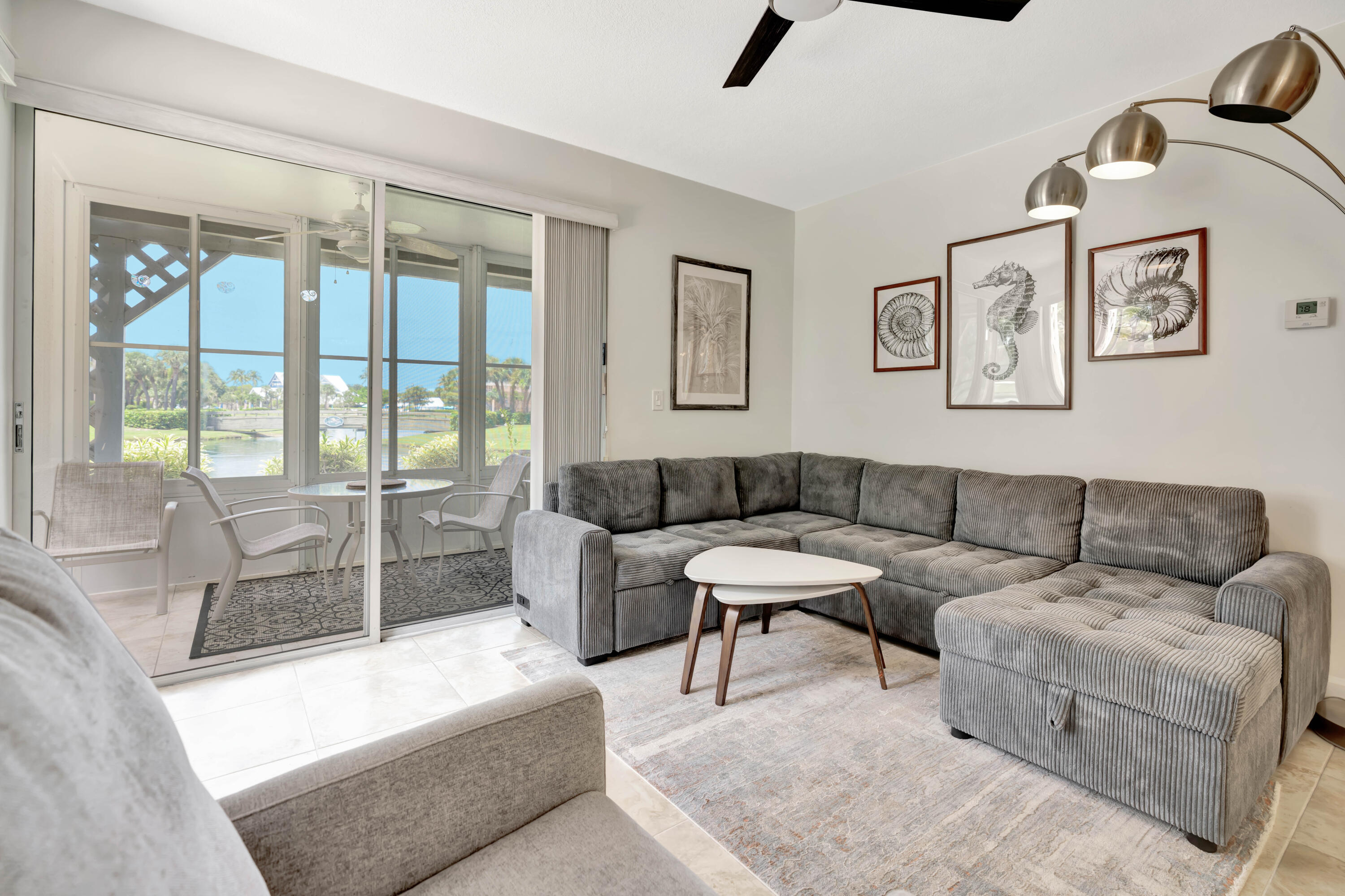 353 Highway 1, Unit A4 Jupiter, FL 33477 - Photo 8 of 51 a living room with furniture and a floor to ceiling window