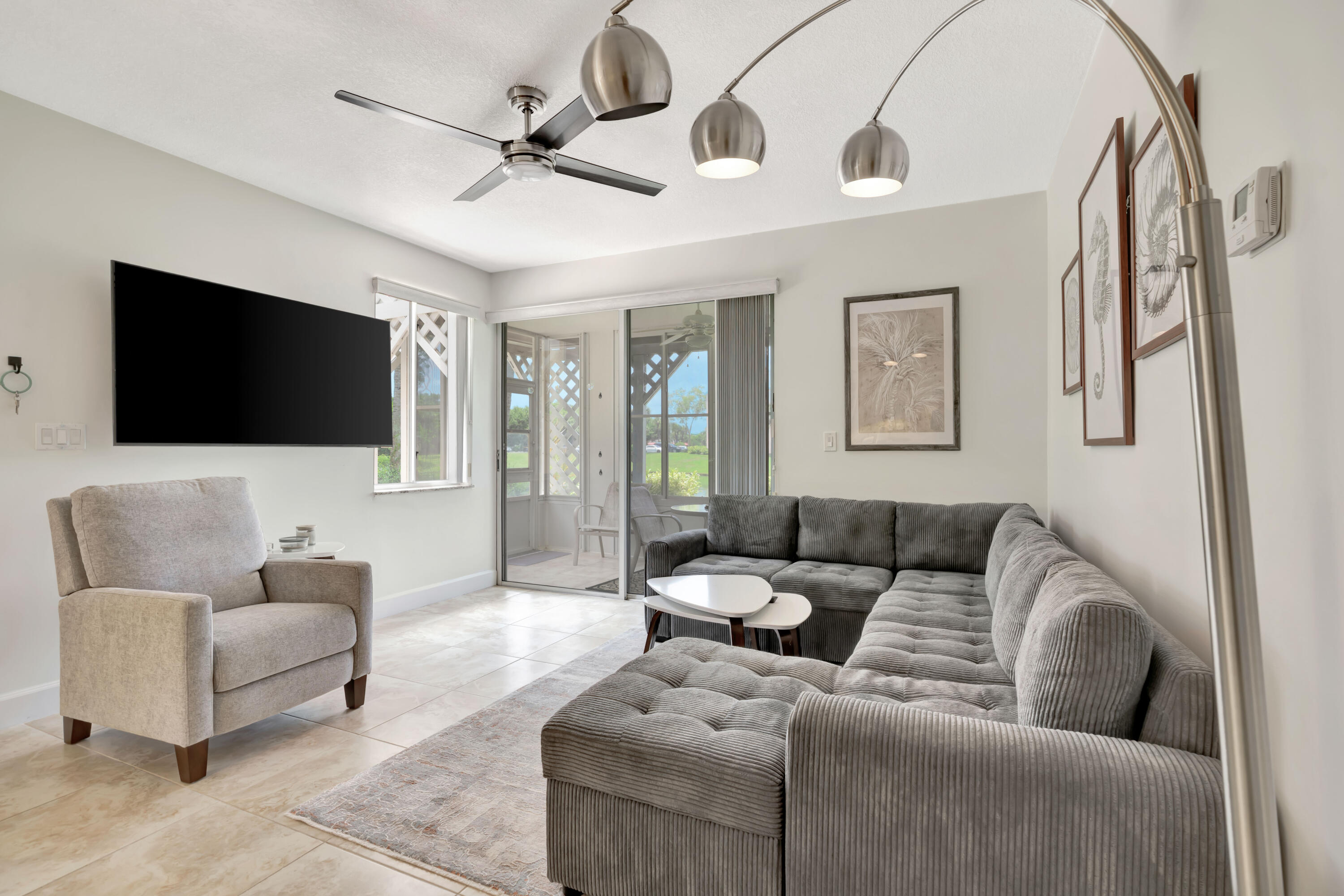 353 Highway 1, Unit A4 Jupiter, FL 33477 - Photo 9 of 51 a living room with furniture and a flat screen tv