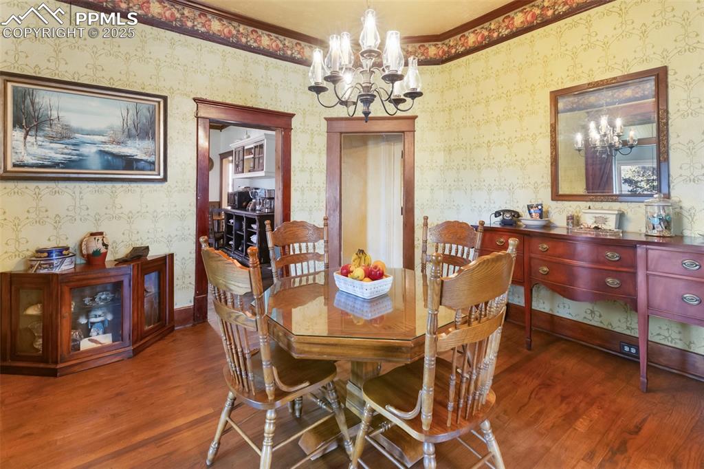 119 South 3rd Street Victor, CO 80860 - Photo 19 of 38 a view of a dining room with furniture and chandelier