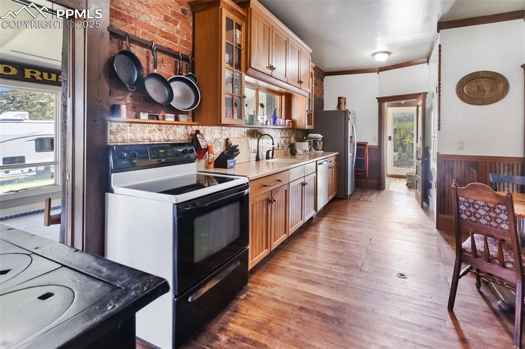119 South 3rd Street Victor, CO 80860 - Photo 27 of 38 a kitchen with stainless steel appliances granite countertop a stove and a wooden floors