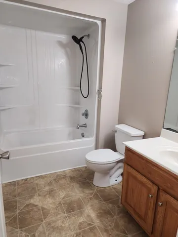 a bathroom with a toilet and a bathtub