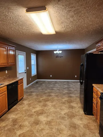 a view of a kitchen with a sink and a refrigerator
