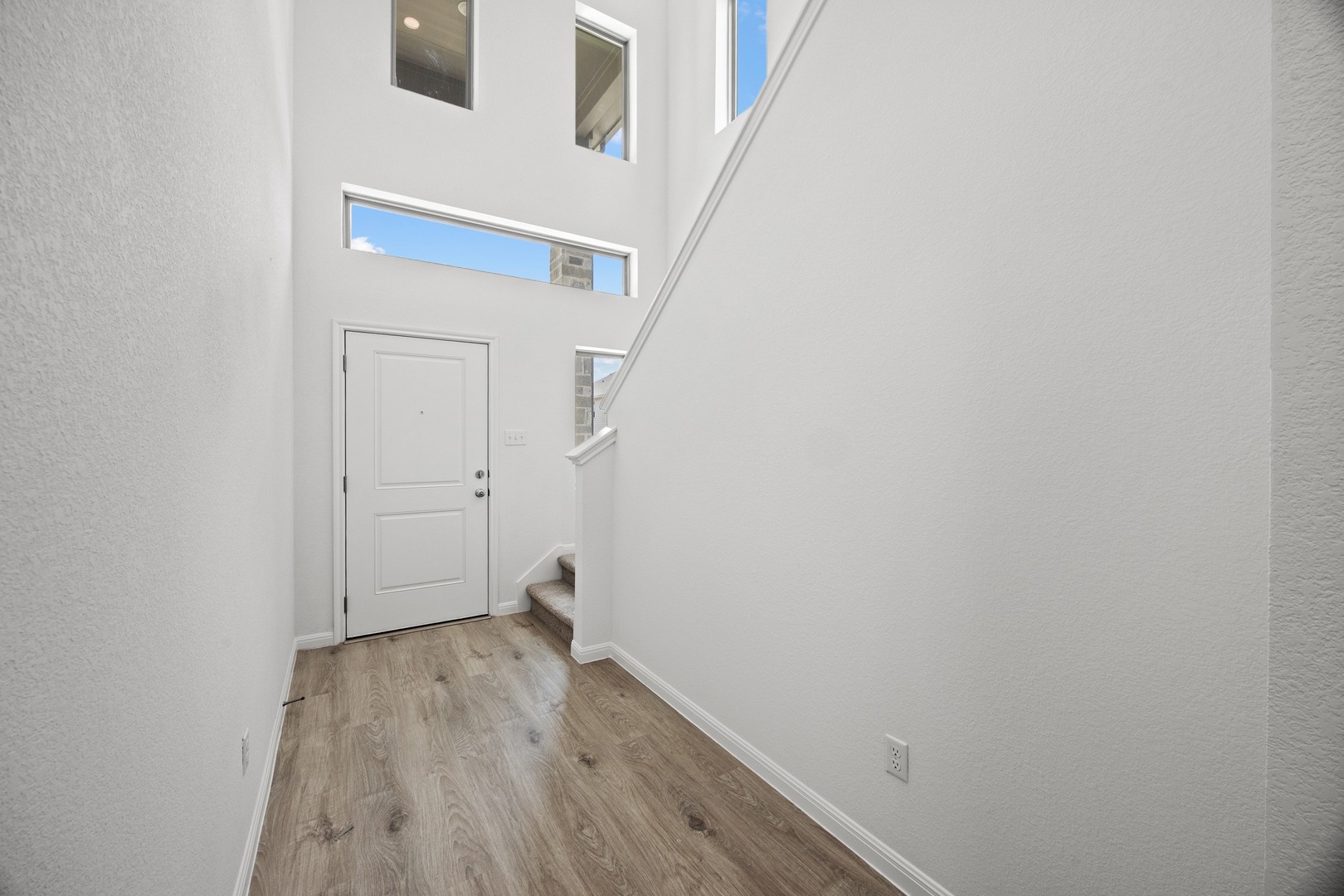 200 Hornet Street Elgin, TX 78621 - Photo 4 of 39 a view of a hallway with wooden floor