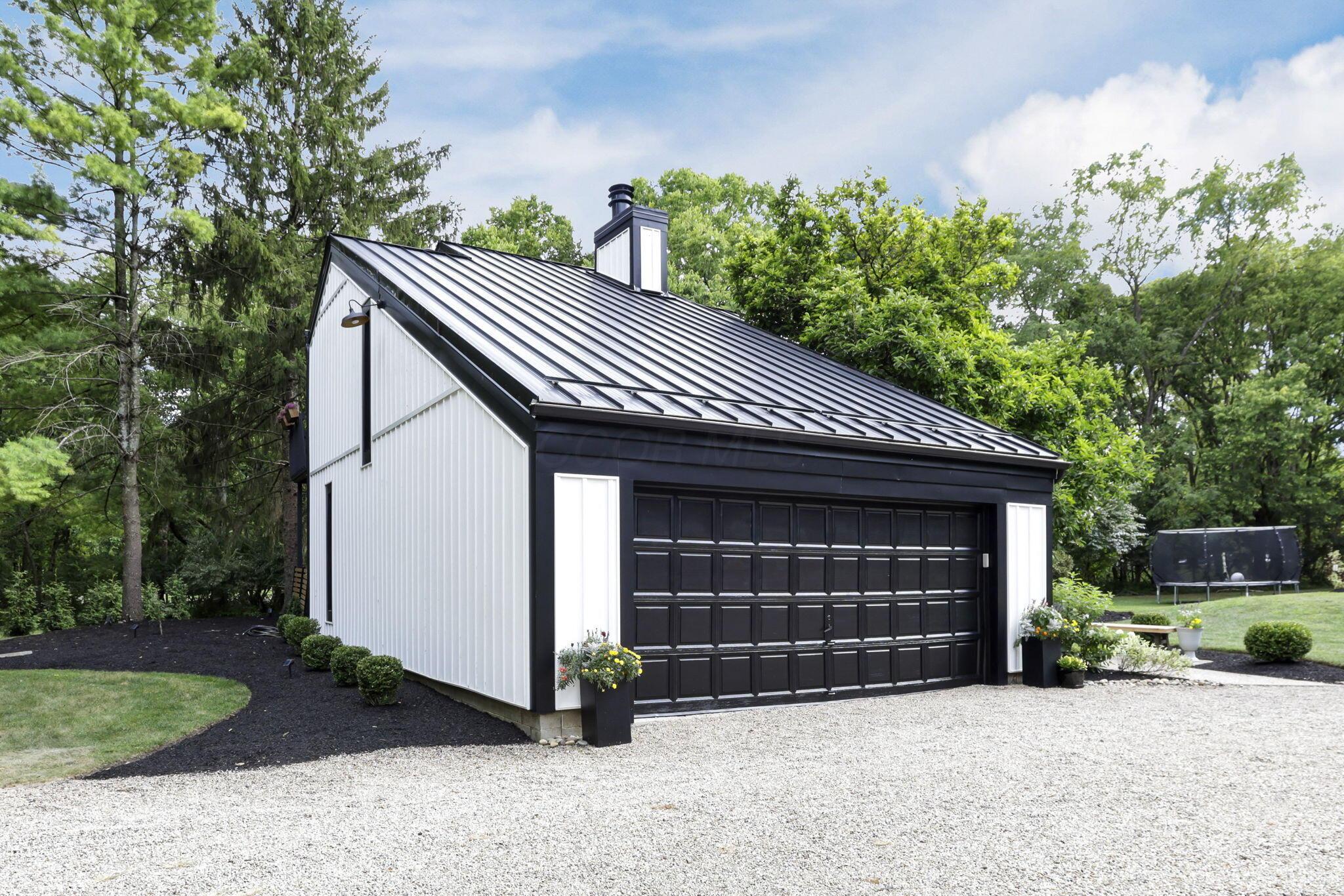 4390 Dublin Road Columbus, OH 43221 - Photo 4 of 83 New Steel Roof "2024", Vertical White Siding, Aluminum Covered Trim, Painted Stucco, Sturdy Painted Garage Door.