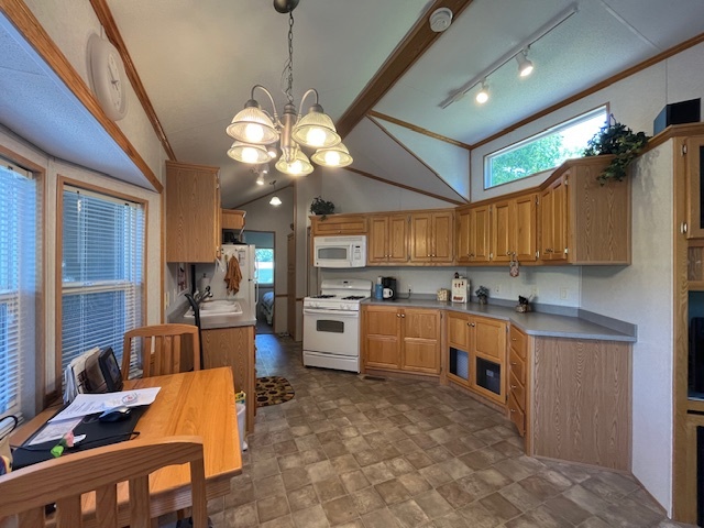 2795 East 28th Road Marseilles, IL 61341 - Photo 7 of 65 a open kitchen with stainless steel appliances granite countertop a sink dishwasher a stove a refrigerator a dining table and chairs with wooden floor