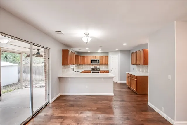 a view of kitchen with sink and refrigerator