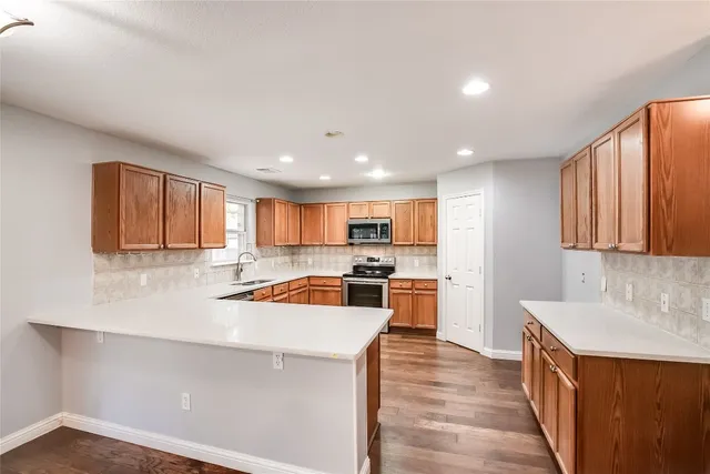 a kitchen with a sink a stove and a refrigerator