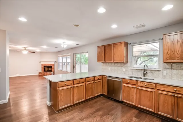 a kitchen with sink a window and cabinets