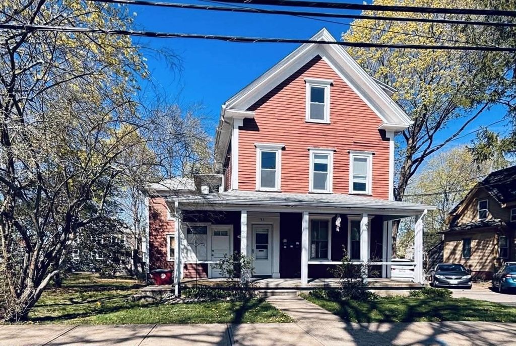 93 Peirce Street, Unit 2 Middleboro, MA 02346 - Photo 1 of 16 a view of a white house with large windows and a small yard