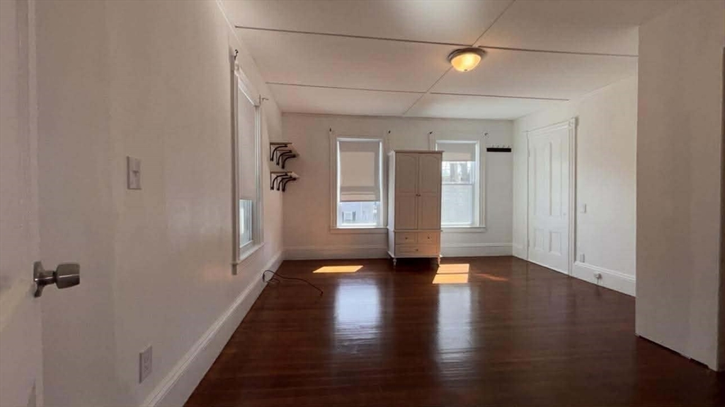 93 Peirce Street, Unit 2 Middleboro, MA 02346 - Photo 12 of 16 a view of a hallway with wooden floor