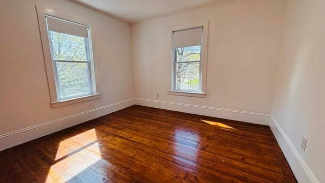 93 Peirce Street, Unit 2 Middleboro, MA 02346 - Photo 15 of 16 an empty room with wooden floor and windows